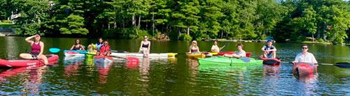 The Kritzer lab members are kayaking on a lake.