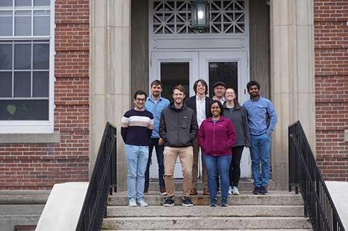 Group of lab members standing on the steps